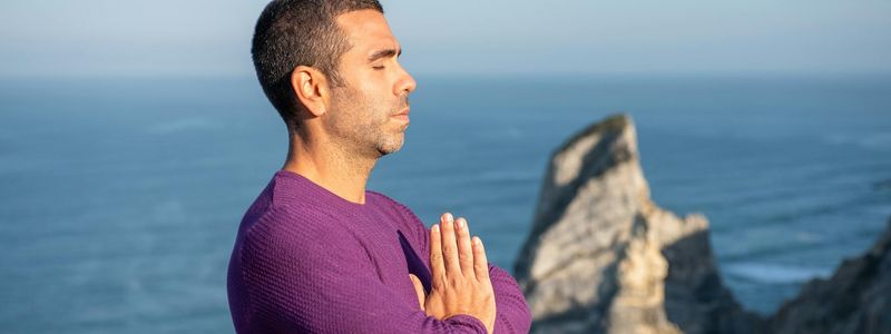 A person in a breathing exercise pose, side view.